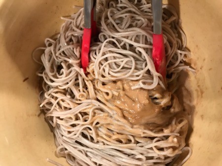mixing Peanut Butter Sauce and Soba Noodles