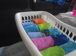 A basket of rolled up washclothes.