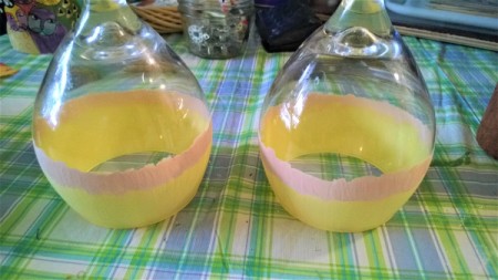 Painted wine glasses, with the first and second stripe of candy corn coloring.
