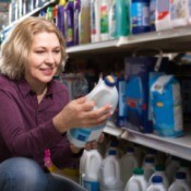 A woman shopping for cleaning products at a store.