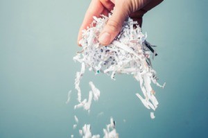Someone holding shredded paper in their hand.
