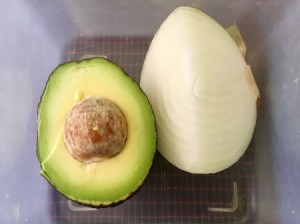 An onion stored with an avocado half.