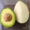 An onion stored with an avocado half.