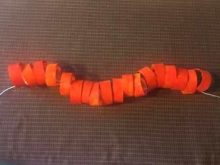 Cardboard Tube Pumpkin - when the orange rings are dry place on a piece of cord
