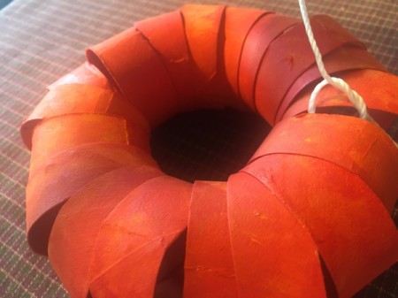 Cardboard Tube Pumpkin - pull into a tight circle, tie, and cut off the extra string