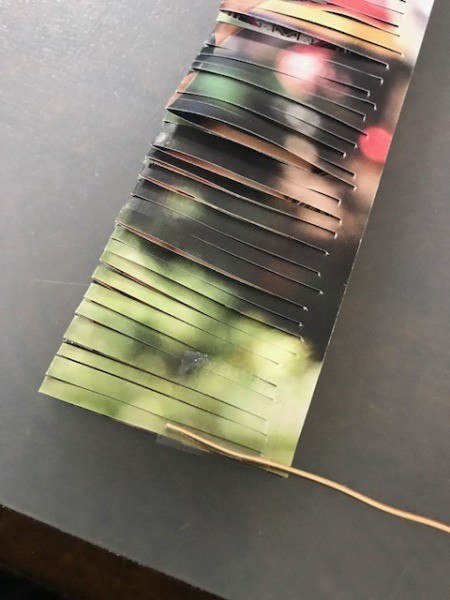 Recycled Catalog Flowers - attach the piece of wire to the end of the strip