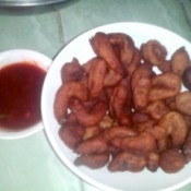 finished Fried Fish Drops on plate with bowl of sauce