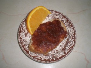 Apple Butter on bread and orange wedge  on plate