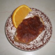 Apple Butter on bread and orange wedge  on plate
