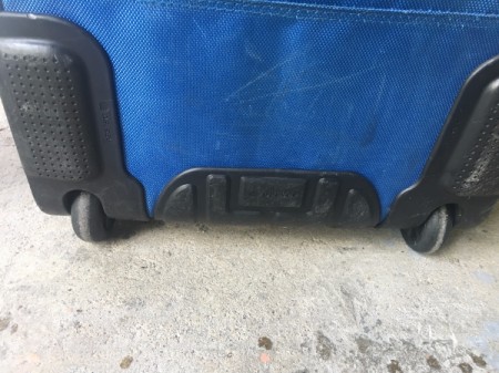 Repairing a Lopsided Luggage Wheel - roll wheel to check for bumps and sand as necessary