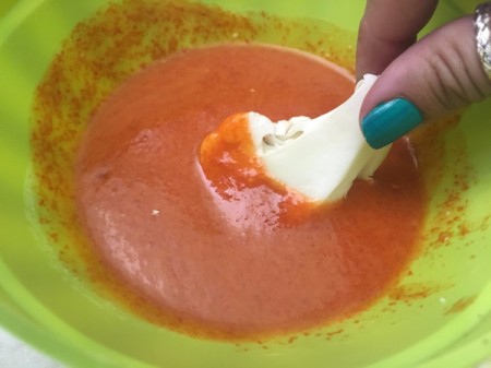 dipping cauliflower in sauce