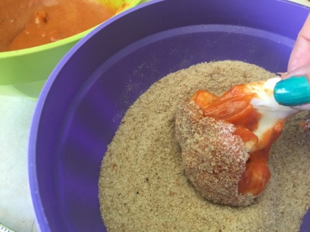 dipping sauced cauliflower in seasoned crumbs