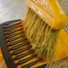 DIY Comb-top Dustpan - large tooth comb on dust pan with broom in place to clean