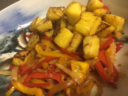 Pineapple added to Peppers and onions in bowl