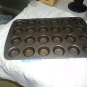 A mini muffin tin on a white towel in the kitchen.