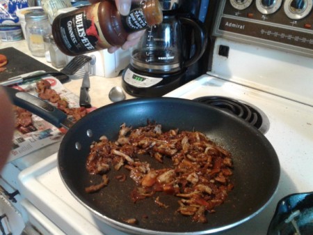 adding BBQ sauce to pulled pork