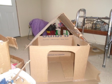 Making a Cardboard Dog House - begin gluing on roof