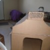 A dog house that has been constructed out of cardboard.