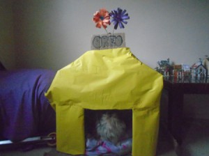 Making a Cardboard Dog House - write dog's name on a piece of cardboard and glue on, cover the front with paper if desired