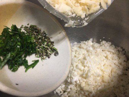 adding herbs and cheese to Cauliflower