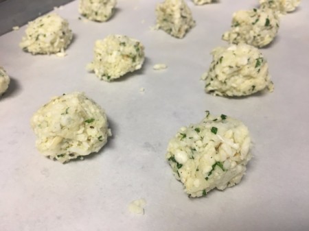 unbaked Cauliflower Cheese Crisps on parchment paper