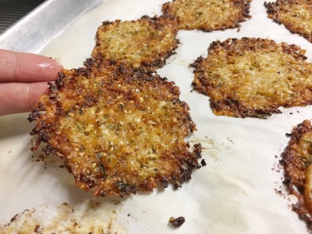 Cauliflower Cheese Crisps baked on parchment paper