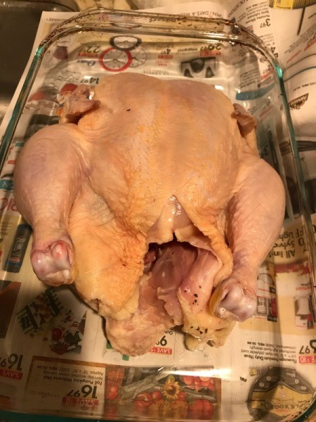 washed whole chicken in glass baking dish
