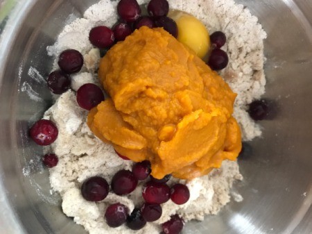 adding pumpkin, cranberries and egg to dry ingredients