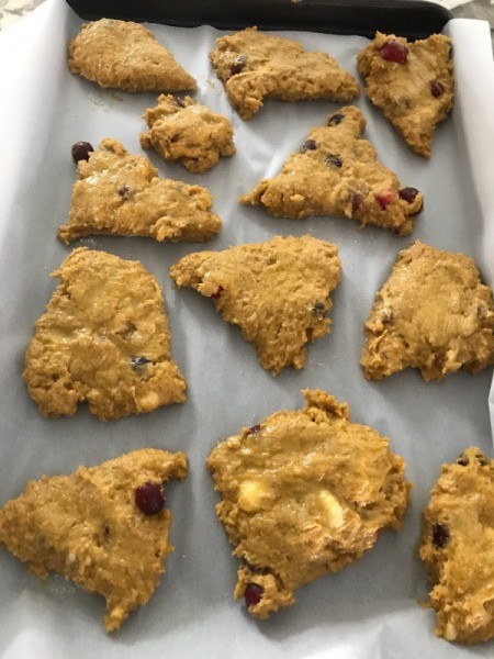 Pumpkin Cranberry Scones on parchment paper