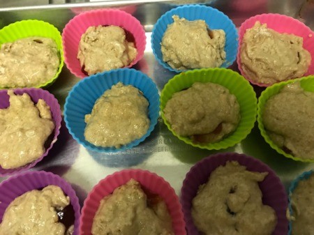 muffin dough in cups over jam