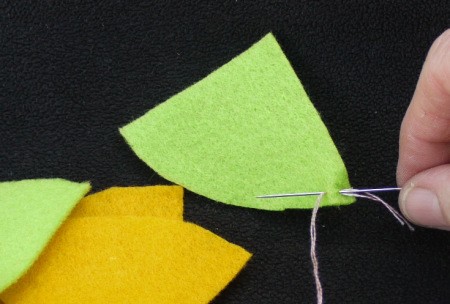Felt Flower Brooch - on the curved corner of one piece make a backstitch to secure thread