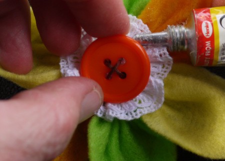 Felt Flower Brooch - stitch button to the center using embroidery floss, you can glue too if needed