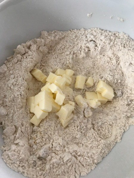 adding butter to dry ingredients