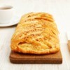 Stuffed breakfast bread braid on a cutting board.