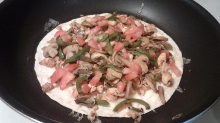 ingredients on tortilla in pan