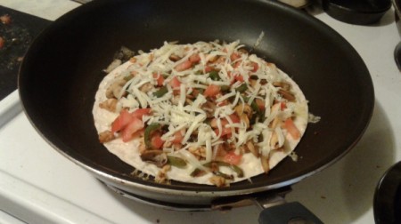 cheese on ingredients on tortilla