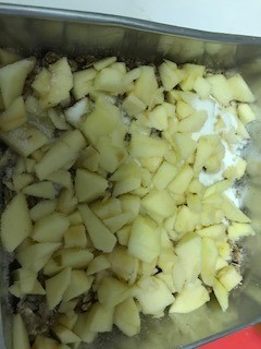 chopped apples on top of mixture in pan