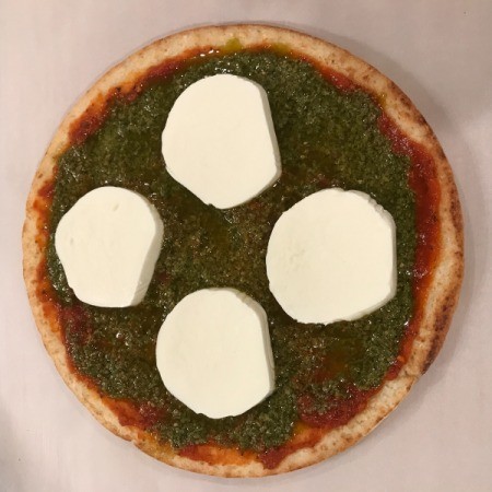 Store-bought pizza crust with mozzerella slices.