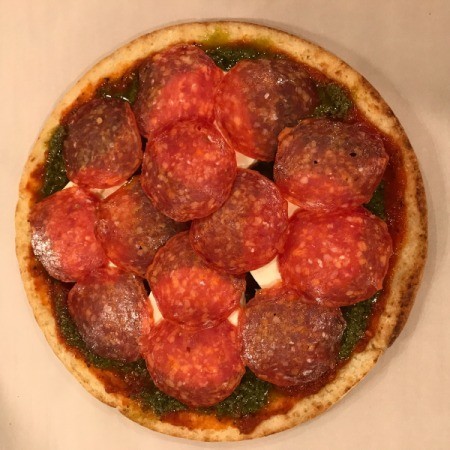 Store-bought pizza crust with pepperoni slices.