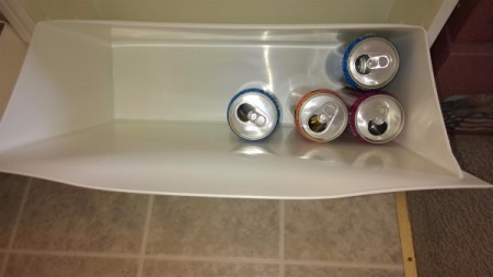 Aluminum cans stored inside white IKEA recycle bins.