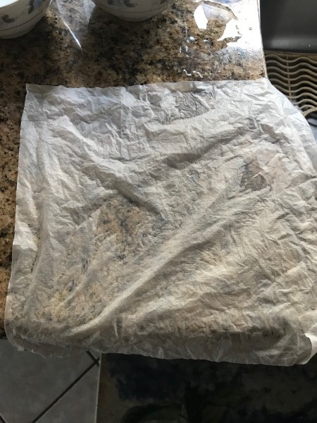 A spread out paper towel, drying on the counter.