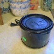 A replacement lid for a mini crockpot from a plastic bowl.
