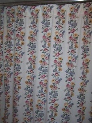 A shower curtain made from a floral bed sheet.