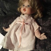 Identifying a Porcelain Doll - doll wearing a pink dress