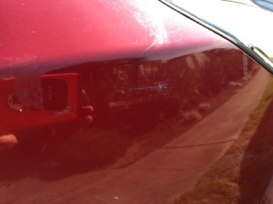 Removing Plastic Label Imprint on Car's Exterior - faint residue of label text on hood