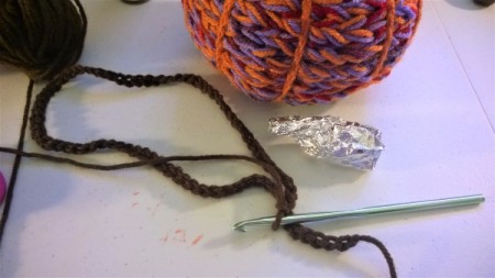 Yarn Bombed Pumpkin - create a foil shaped stem and make a chain using the brown yarn