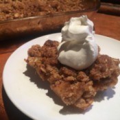 Healthy Apple Crisp on plate with whipped cream