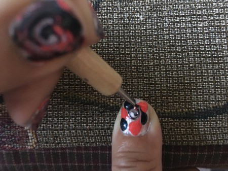 Quick Marbled Nail Art - with your tool begin working the colors together from the center out