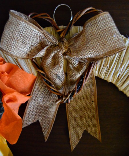 Lotus Pod and Crepe Paper Fall Wreath - hot glue the bow and the twig heart to the wreath