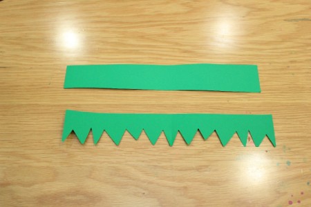 Halloween Frankenstein Soda Bottle Craft - cut jagged bottom on green paper strip for hair
